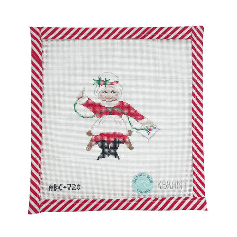 Mrs. Claus Needlepointing Santa