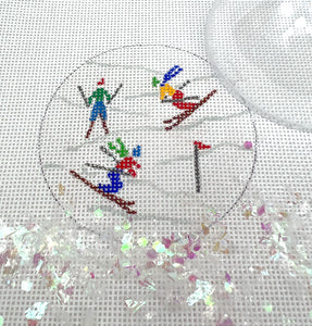 Clear dome and confettI-skiers on sparkly white slopes